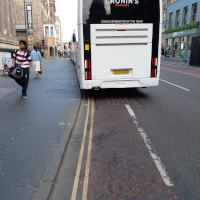 A photo of a bike lane with a car in it