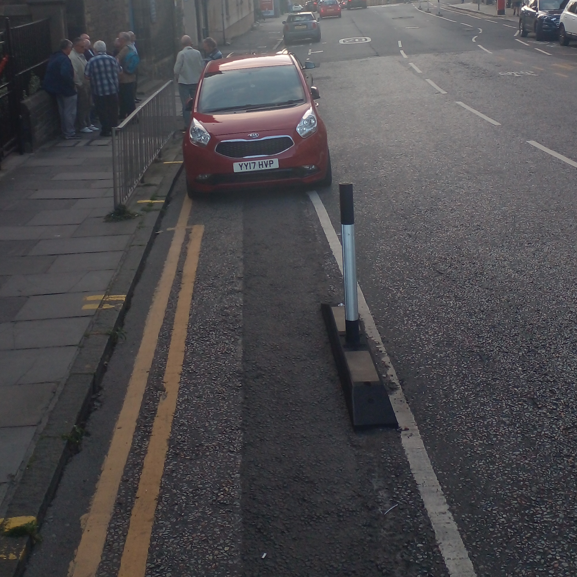 A photo of a bike lane with a car in it