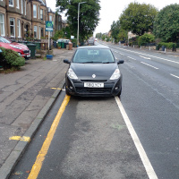 A photo of a bike lane with a car in it