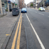 A photo of a bike lane with a car in it