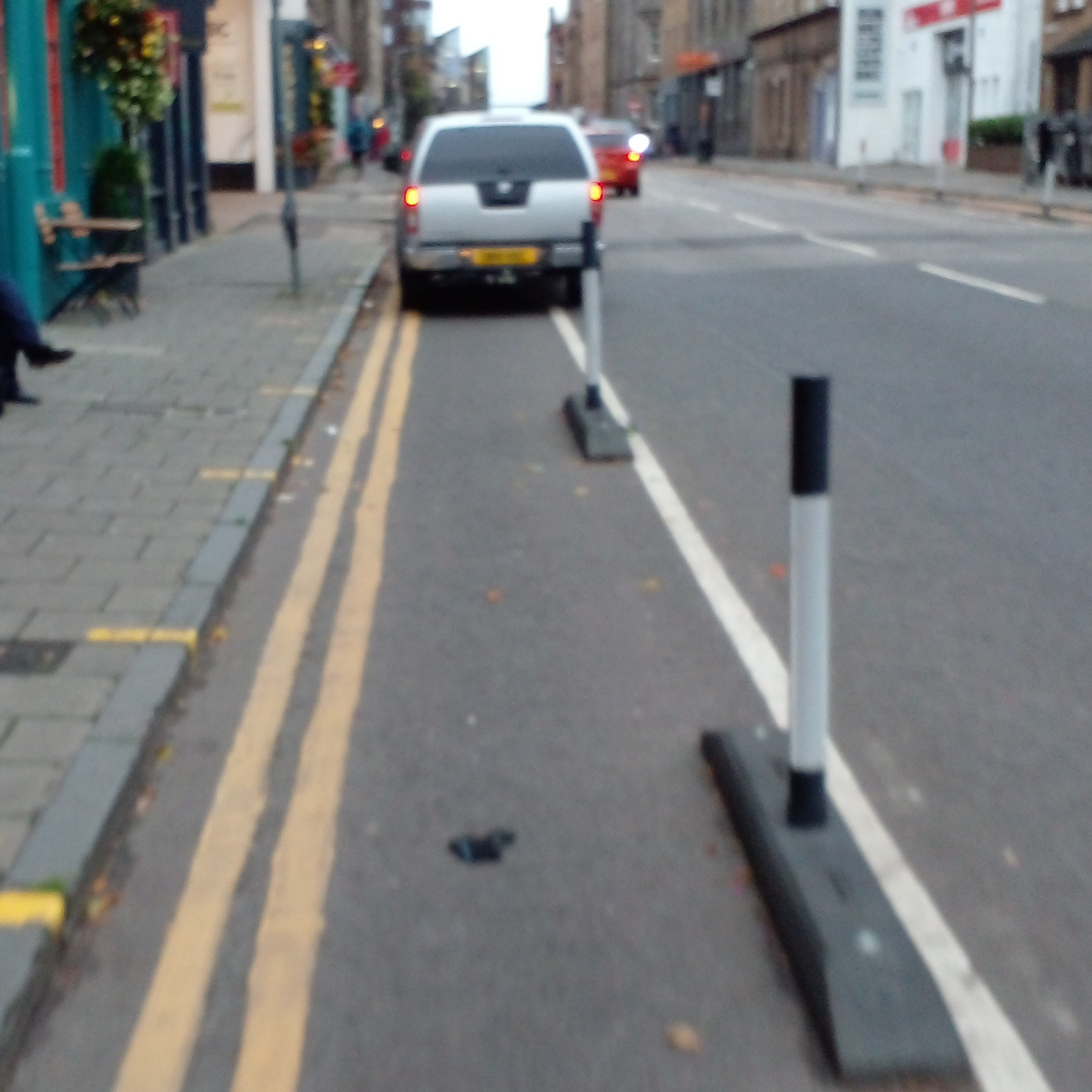 A photo of a bike lane with a car in it