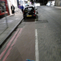 A photo of a bike lane with a car in it